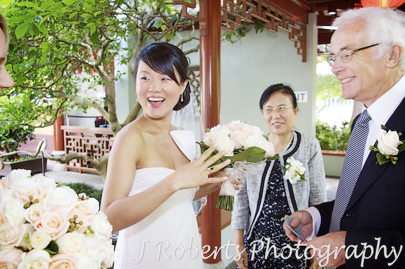 Bride laughing and showing off her something borrowed and blue - wedding photography sydney